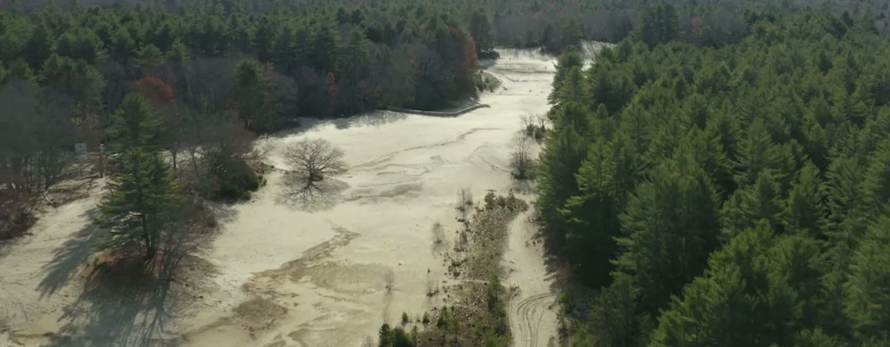 Aerial view of the Desert of Maine, a patch of dunes ringed by forest